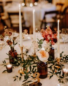 the table is set with candles and flowers