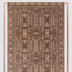 a brown rug with an intricate design on it