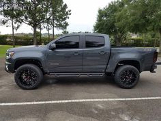 a gray truck parked in a parking lot