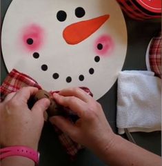 someone is making a snowman out of paper plates