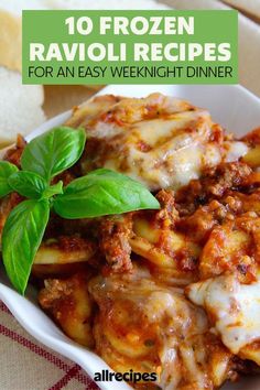 a white bowl filled with pasta covered in sauce and topped with fresh basil leaves, on top of a red checkered table cloth