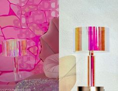 a pink lamp next to a white chair and a wall with colorful designs on it