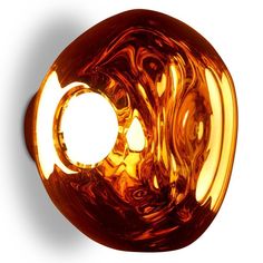 an orange glass object is shown against a white background with the light reflecting off it's surface