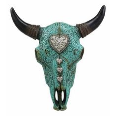 a cow's head with horns decorated with jewels and heart shaped brooches