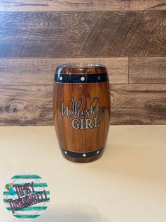 a wooden barrel with the words whiskey girl painted on it