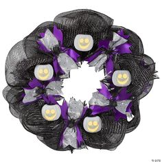 a black mesh wreath with skulls and purple ribbons