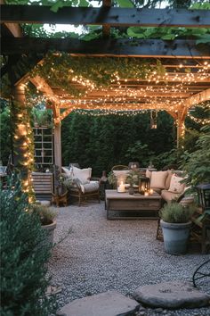 an outdoor living area is lit up with fairy lights