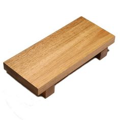 a small wooden shelf sitting on top of a white surface