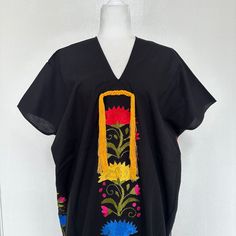 This hand-woven two panel Mexican Yalalag Hupil long tunic is a VINTAGE CLASSIC with flowers embroidered by hand by artisans of Oaxaca 100% handmade. A relaxed style and at the same time looks very elegant for a party in the morning or afternoon. It is made of 100% cotton blanket fabric. MADE IN MEXICOBy: Mexican ArtisansFor: Women Size: M/L Color: black | multi Length: 41.5" Details: Material: cotton silk Non-stretch Embroidered thread Front & back tassels Ankle Length Washing Instructions: Ple Folk Style Cotton Kaftan With Floral Embroidery, Traditional Floral Embroidered Short Sleeve Tunic, Traditional Floral Embroidery Tunic With Short Sleeves, Traditional Short Sleeve Tunic With Floral Embroidery, Traditional Tunic For Spring, Traditional Free Size Tunic For Spring, Spring Bohemian Kaftan For Traditional Ceremonies, Folk Kaftan With Floral Embroidery For Traditional Ceremonies, Folk Style Kaftan With Floral Embroidery For Ceremonies