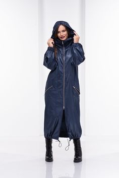 "This long raincoat has a large hood that can be put inside the collar with a zipper. Modern design with long double side zipper and two side pockets also with zippers. Adjustable tie on the bottom hem and nice elastics finishes of the sleeves turn this model into a fabulous \"must-have\" design for the new season. The model in the picture is 168cm. ⅼ 5.6 ft. tall and is wearing size S / color: Dark blue * Worldwide EXPRESS shipping - please provide a phone number for shipping documents * US Siz Jacket Cyberpunk, Womens Rain Jacket, Cyberpunk Jacket, Long Raincoat, Women's Puffer Coats, Steampunk Jacket, Cyberpunk Clothes, Long Rain Coat, Hooded Trench Coat