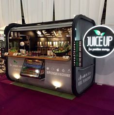 the juice up booth is set up with purple carpet and white drapes on the walls