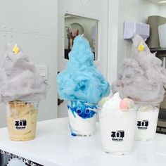 three ice cream sundaes sitting on top of a counter next to each other