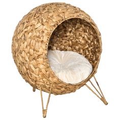 a wicker chair with a white cushion on it's back legs and feet