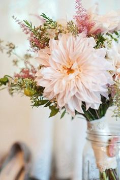 a vase filled with flowers sitting on top of a table