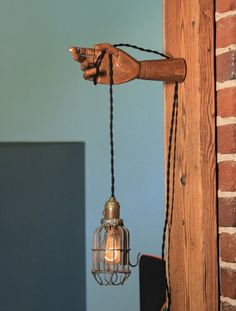 a light that is on the side of a brick wall next to a lamp fixture