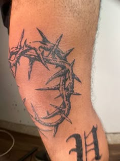 a man's arm with barbed wire on it and the number 11 in front of him