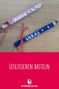 two pencils with name tags attached to them on a wooden table next to a pink ribbon