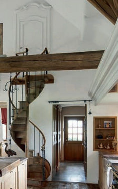 an open kitchen with stairs leading up to the second floor