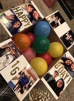 some balloons are sitting in a box on the floor next to pictures and cards that say happy birthday