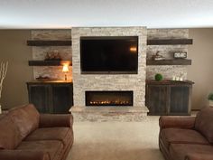 a living room with two couches and a fireplace