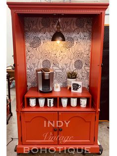 an orange display case with coffee cups on it