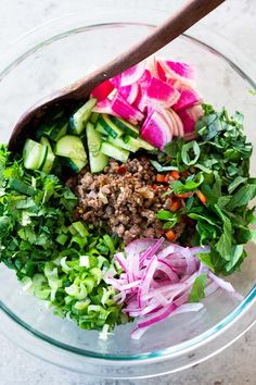 a glass bowl filled with chopped vegetables and meat