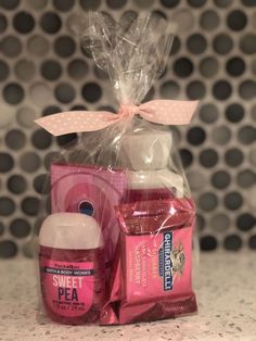 a pink gift basket with body care products in it