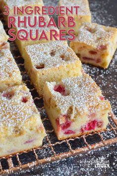 the three ingredient rhubarb squares are sitting on a cooling rack with powdered sugar