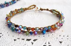 multicolored beaded bracelet on white doily