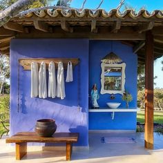 a blue and white house with clothes hanging on the wall