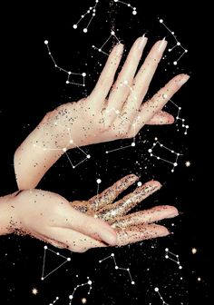 two hands with gold glitter on them reaching up into the air