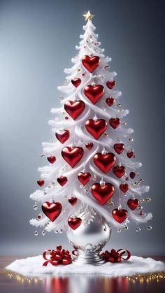 a white christmas tree with red hearts on it