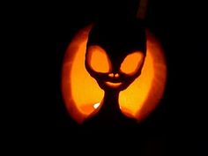 an image of a cat pumpkin carving in the dark