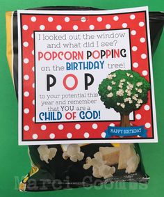 a bag of popcorn with a happy birthday card in it's front and an image of a tree on top