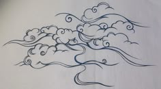 a drawing of a tree with clouds in the sky on a sheet of white paper