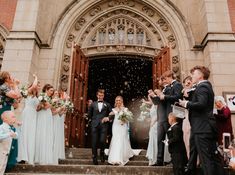 a bride and groom are leaving the church with their guests throwing confetti in the air