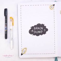 an open notebook with the words brain dump on it next to a pen and marker