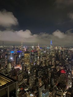 an aerial view of new york city at night from the top of the empire building