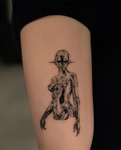 a woman's leg with a tattoo on it that has an image of a skeleton holding a baby