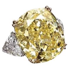 Magnificent classic design for this refined ring in 18k gold with a GIA certified natural fancy yellow diamond , cushion cut, of 5,00carats, VVS2 clarity, so clean and brilliant, with two side natural diamonds in trillions cut . A very piece of art. Investment ring. Complete with GIA report. Whosale price. Fancy Yellow Diamond Ring, Radiant Diamond Rings, Yellow Diamonds Engagement, Cushion Diamond Ring, Yellow Diamond Engagement Ring, Yellow Cushion, Cushion Cut Diamond Ring, Art Investment, Yellow Diamond Rings