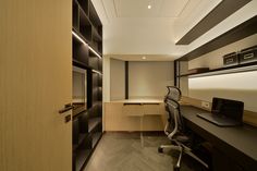 an office with a desk, computer and shelves