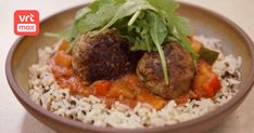 meatballs and rice in a bowl on a table