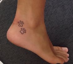 a small paw print on the foot of a woman