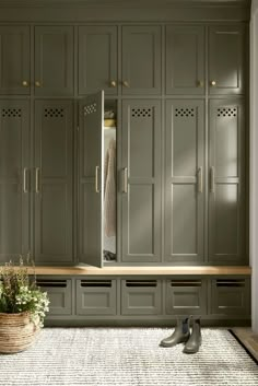 a large closet with lots of cabinets and shoes on the floor in front of it