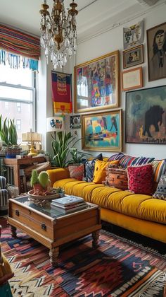 a living room filled with lots of furniture and pictures on the wall above it's windows