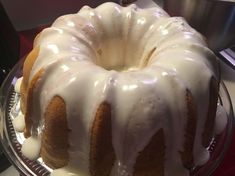 a bundt cake with white icing on a glass plate