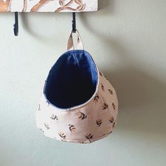 a purse hanging from a hook on a wall