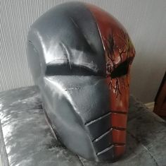 Description  A full head helmet based on the DC Villain Deathstroke. This makes the perfect addition to a fancy dress costume, cosplay event or for display purposes.  Materials Used  * EVA Foam  * Contact Cement  * Hot Glue  * Acrylic Paints  * Flexi Paint  * Spray Paints  * Varnish  If you are allergic to any materials we would urge you to contact us before purchase to ensure the item would be safe for you to use.  Custom Design  Products are made upon an order being placed and each design can Deathstroke Dc, Villain Cosplay, Full Head Mask, Head Mask, Costume Masks, Dc Villains, Fancy Dress Costume, Spray Paints, Deathstroke