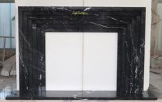 a black and white marble fireplace in a room