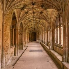 the inside of an old building with many arches and columns on either side of it